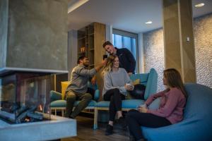 a group of people sitting in a living room at mi-pad Queenstown in Queenstown