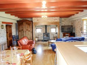 a living room with a couch and a table at Holiday Home Sourdoire by Interhome in La Chapelle-aux-Saints