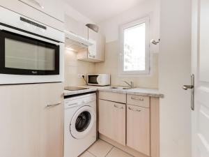 a kitchen with a washing machine and a microwave at Apartment Le Kappas in Nice