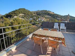 a patio with a table and chairs on a balcony at Apartment Taverna Il Cippo by Interhome in Mortola Superiore