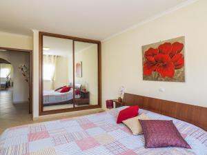 a bedroom with a large bed and a mirror at Apartment T2 Olhão by Interhome in Olhão +13 photos