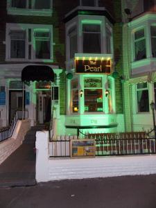 a sign that says the dead on the front of a building at Pearl Hotel in Blackpool