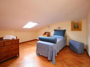 a bedroom with a bed and a dresser at Villa Paolotti by Interhome in Bettona