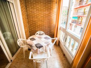 stół i krzesła w pokoju z oknem w obiekcie Apartment Edificio Belen V by Interhome w mieście Torrevieja