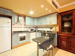 a kitchen with a table and a refrigerator at Apartment Delicias B by Interhome in Sant Carles de la Ràpita