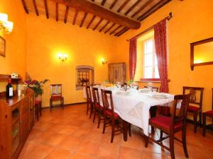 a dining room with a white table and chairs at Villa Paolotti by Interhome in Bettona