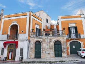 a group of buildings with green doors and balconies at Apartment Carovigno by Interhome in Carovigno