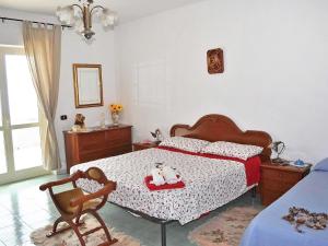 a bedroom with a bed with two stuffed animals on it at Holiday Home Path of the Gods by Interhome in Pianillo
