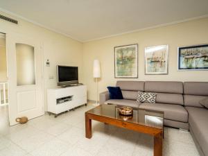 a living room with a couch and a tv at Apartment Sorolla-1 by Interhome in Jávea