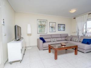 a living room with a couch and a coffee table at Apartment Sorolla-1 by Interhome in Jávea +23 photos