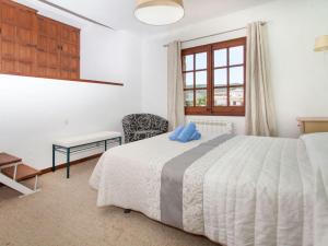 a bedroom with a white bed and a window at Holiday Home Cabanyes by Interhome in Calonge