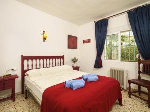 a bedroom with a bed with two towels on it at Holiday Home La Caissa by Interhome in Benitachell