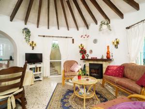 a living room with a couch and a table at Holiday Home La Caissa by Interhome in Benitachell