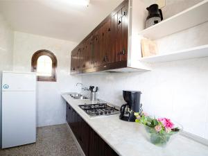 a kitchen with a sink and a stove top oven at Villa Halibut by Interhome in Fanadix