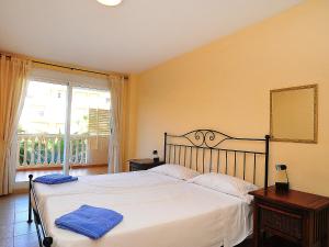 a bedroom with a bed and a large window at Apartment Nou Fontana-4 by Interhome in Jávea