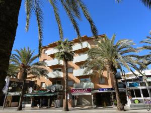 a building with palm trees in front of it at Apartment Terecel Salou-1 by Interhome in Salou