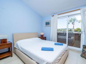 a bedroom with a bed and a large window at Apartment Menorca-3 by Interhome in Balcon del Mar