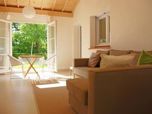 a living room with a couch and a table at Holiday Home Lapeyriere by Interhome in Saint-Pantaléon