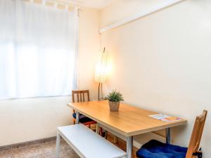 a dining room with a wooden table and chairs at Apartment Camp Nou- Travessera de les Corts by Interhome in Barcelona