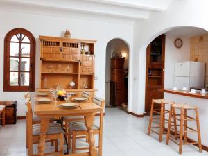 a kitchen and dining room with a wooden table and chairs at Holiday Home Solenza by Interhome in Calonge