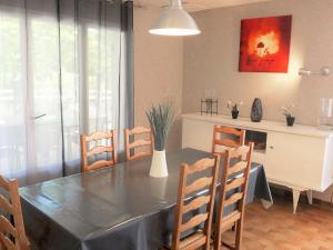 a dining room with a black table and chairs at Holiday Home Roumagnac by Interhome in Cavalaire-sur-Mer