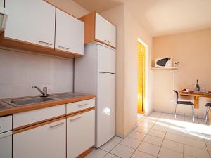 a kitchen with a sink and a refrigerator at Studio Royal Delta-3 by Interhome in Riumar