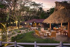 a resort with a restaurant with tables and chairs at Eco Casita 11 in Rivas