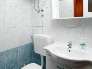 a bathroom with a toilet and a sink at Apartment Šarenko-1 by Interhome in Vela Luka +4 photos