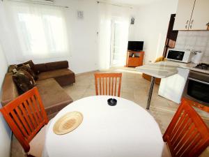 a living room with a white table and chairs at Holiday Home Parunov by Interhome in Rogač