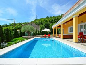 a swimming pool in the backyard of a house at Holiday Home Villa Olea by Interhome in Opatija