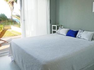 a bedroom with a large bed with a large window at Apartment Marenia by Interhome in Denia