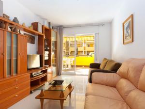 a living room with a couch and a tv at Apartment Cascadas de la Marina-4 by Interhome in Denia