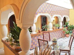 a patio with a table and chairs in a house at Holiday Home La Poza by Interhome in Campanillas