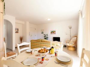 デニアにあるApartment Cascadas de la Marina-3 by Interhomeのキッチン、リビングルーム(テーブル、椅子付)