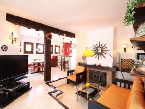 a living room with a television and a fireplace at Holiday Home Krumel by Interhome in Moraira