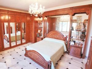 a bedroom with a bed and a chandelier at Holiday Home La Poza by Interhome in Campanillas
