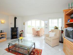 a living room with a tv and a couch and a table at Holiday Home B&B by Interhome in Calpe