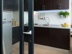 a kitchen with black cabinets and a sink at Holiday Home Gineprino-3 by Interhome in Marina di Bibbona