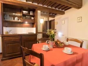 a kitchen with a table with a red table cloth at Apartment Montecorneo-5 by Interhome in Montebello