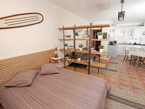 a bedroom with a bed and a dining room at Studio Studio Ericeira by Interhome in Ericeira