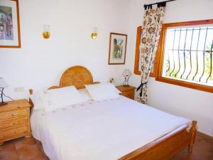 a bedroom with a large white bed and a window at Holiday Home Gabi by Interhome in Monte Pego