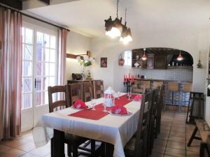 a dining room with a table with a white table cloth at Holiday Home Fromental by Interhome in Bagnac