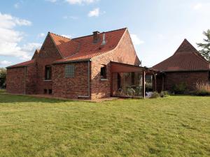 an old brick house with a large yard at Holiday Home La Ferme de Gabrielle by Interhome in Le Bizet