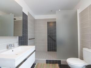 a bathroom with a sink and a toilet and a shower at Holiday Home La Hulotais by Interhome in Saint Malo