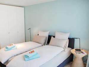 two beds sitting next to each other in a room at Apartment LaVille B-3-2 by Interhome in Locarno