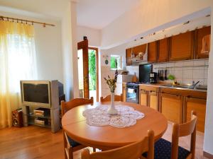 kuchnia z drewnianym stołem z wazonem w obiekcie Apartment Zvonko-2 by Interhome w mieście Lovran +20 zdjęć