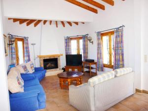 a living room with two blue couches and a fireplace at Holiday Home Gabi by Interhome in Monte Pego