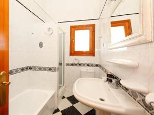 a white bathroom with a sink and a toilet at Holiday Home Del Azahar by Interhome in Monte Pego +11 photos