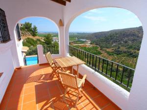 a balcony with a table and chairs and a view at Holiday Home Del Azahar by Interhome in Monte Pego