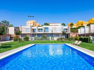 a large swimming pool in front of a building at Holiday Home Xaloc in L'Ampolla